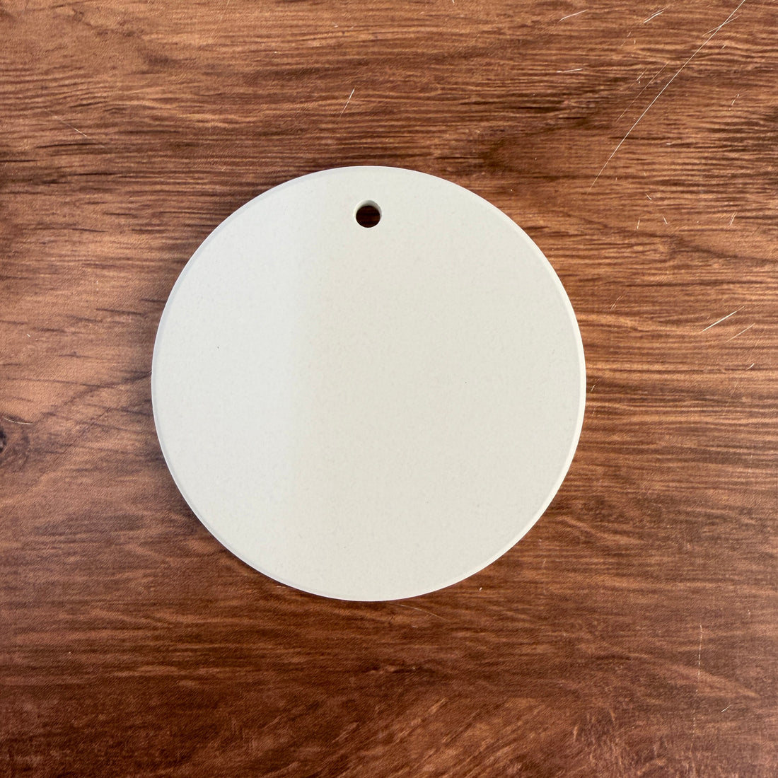 Bright white ceramic ornament blank for UV printing, 3 in round, shown with the gold hanging string